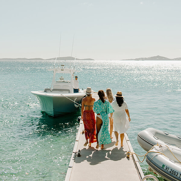group of girls walking towards charter boat in st thomas