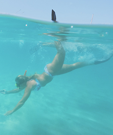 woman diving on snorkel charter with drift